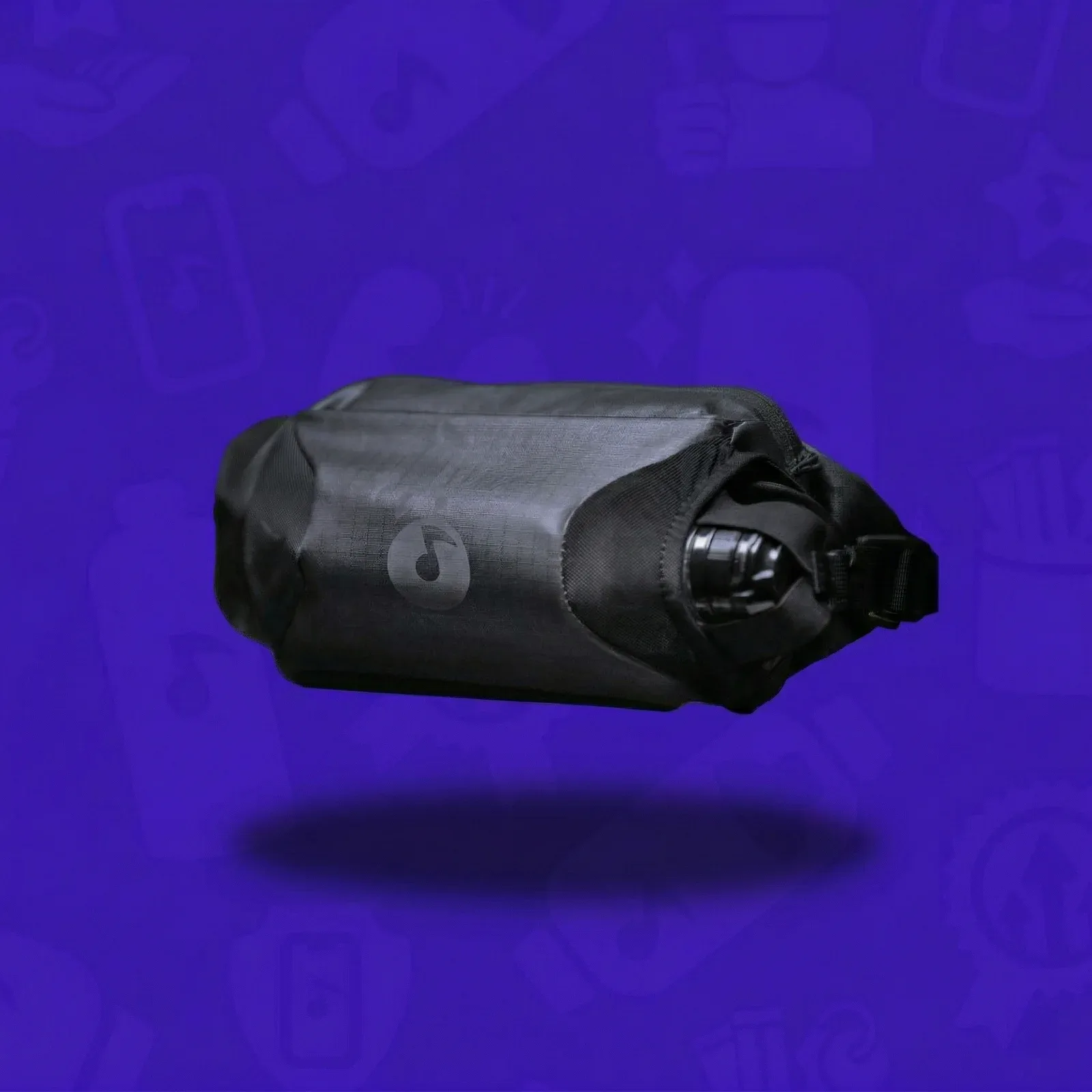 Black Lunchbox Sling Pack with insulated bottle pocket on a purple background.
