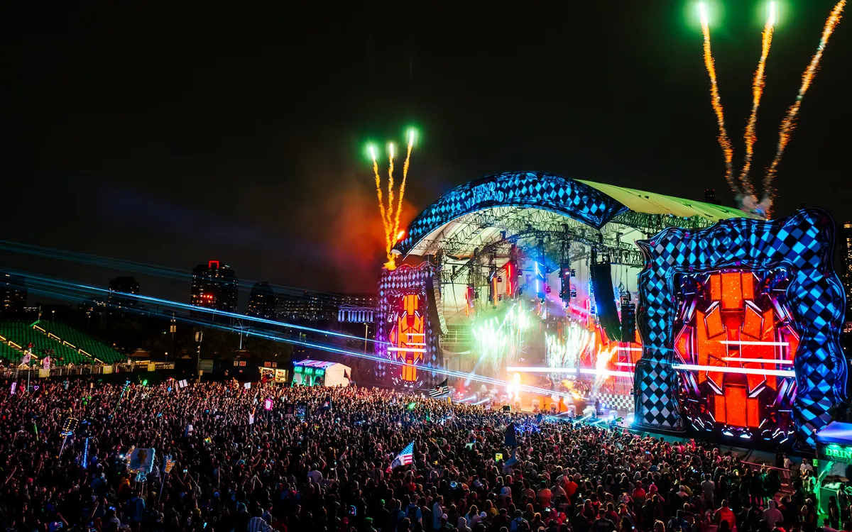 The Beyond Wonderland Midwest stage lit at night beside the Chicago skyline