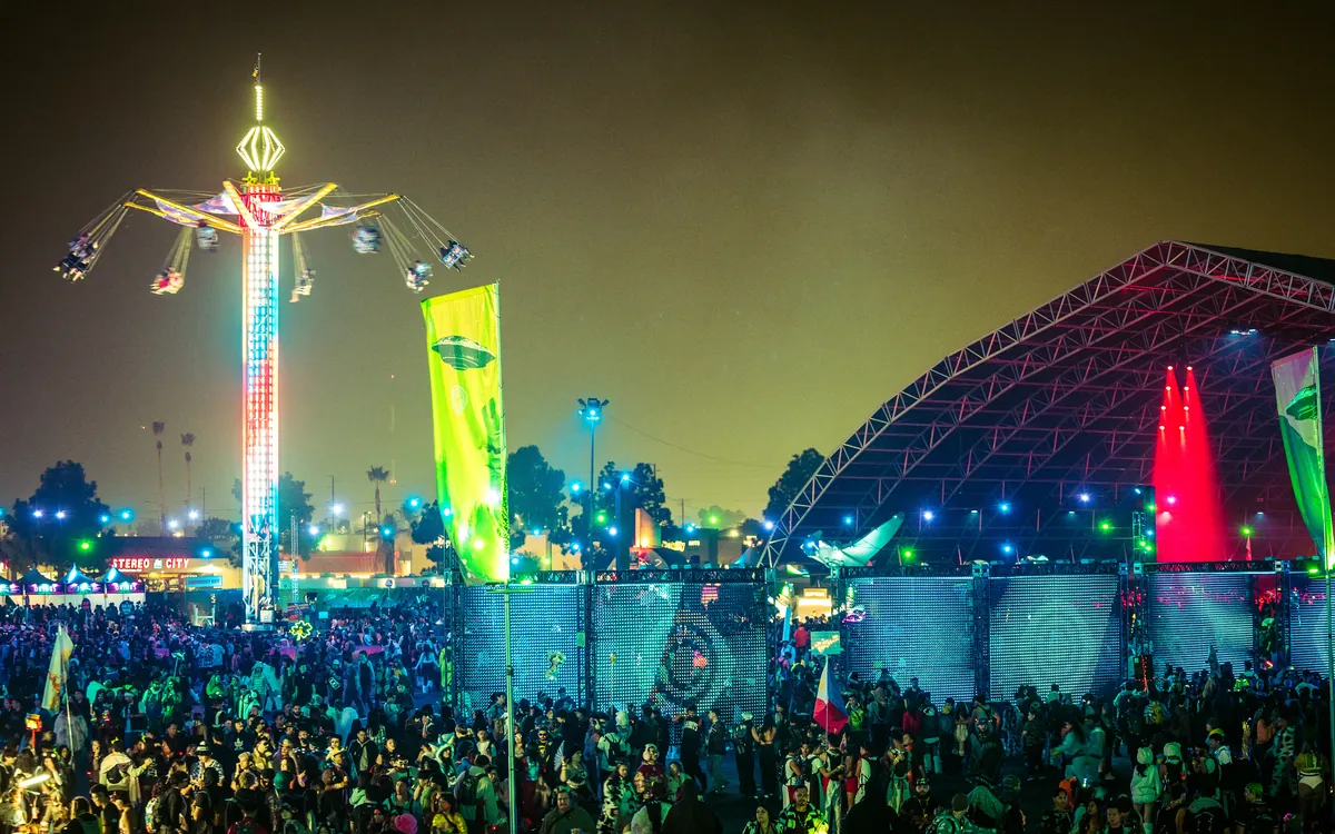 Countdown NYE stages glowing beyond a nighttime crowd