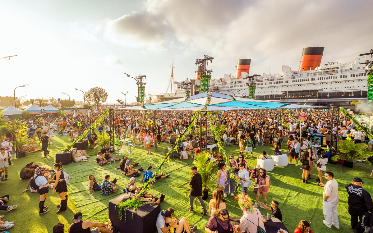 A daytime crowd gathered beside the Queen Mary for Day Trip Festival