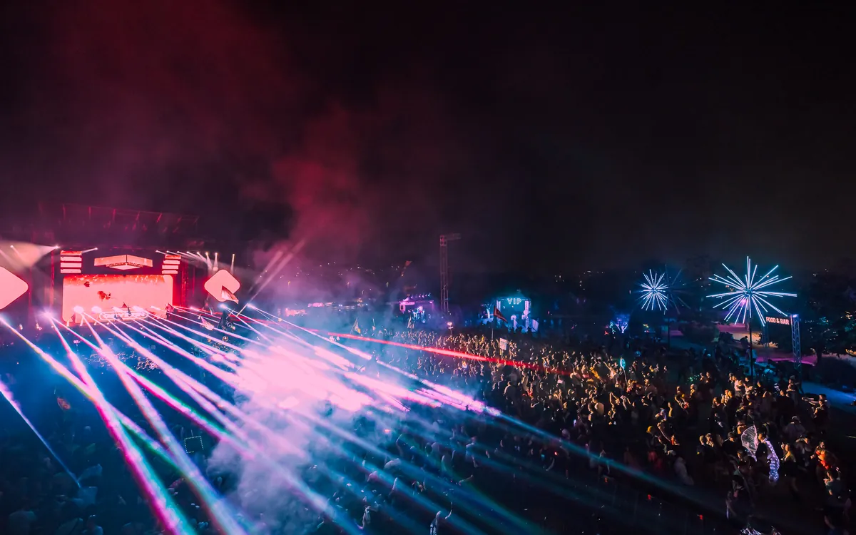 The Lost In Dreams stage lit in pink across a nighttime crowd