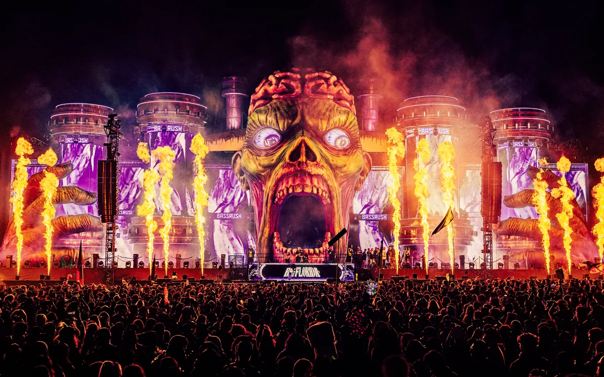 The Apocalypse: Zombieland stage glowing above a nighttime festival crowd